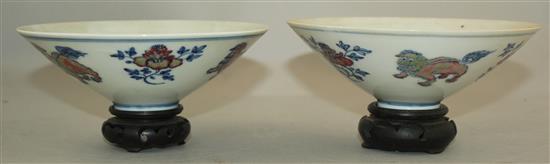 A pair of Chinese underglaze blue and copper red conical bowls, Jiajing marks, late 19th / early 20th century, 15.5cm, wood stand